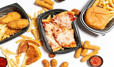 a selection of takeout food including fries, a burger, and various fried foods